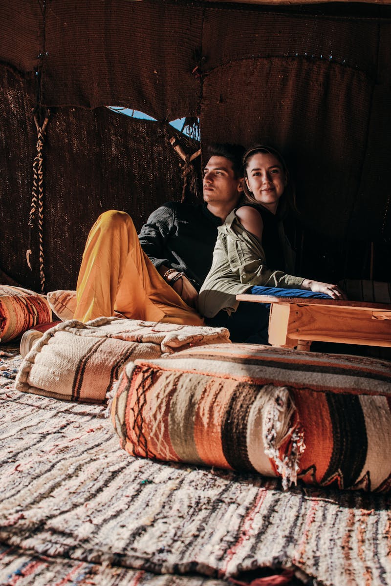 Young couple enjoying leisure time in a cozy Merzouga tent. Cultural and romantic atmosphere.,Errachidia to Merzouga