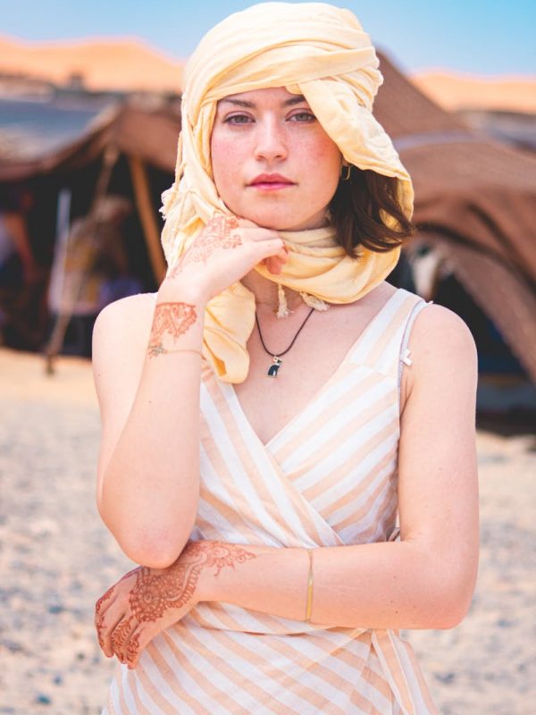 Errachidia to Merzouga: Experience the Desert Magic in 2 Day 6 Caucasian woman in a headscarf with henna tattoos in Merzouga, Morocco desert.,Errachidia to Merzouga