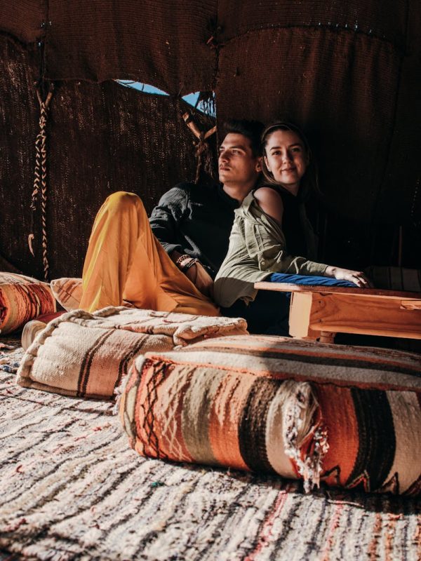 Errachidia to Merzouga: Experience the Desert Magic in 2 Day 5 Young couple enjoying leisure time in a cozy Merzouga tent. Cultural and romantic atmosphere.,Errachidia to Merzouga