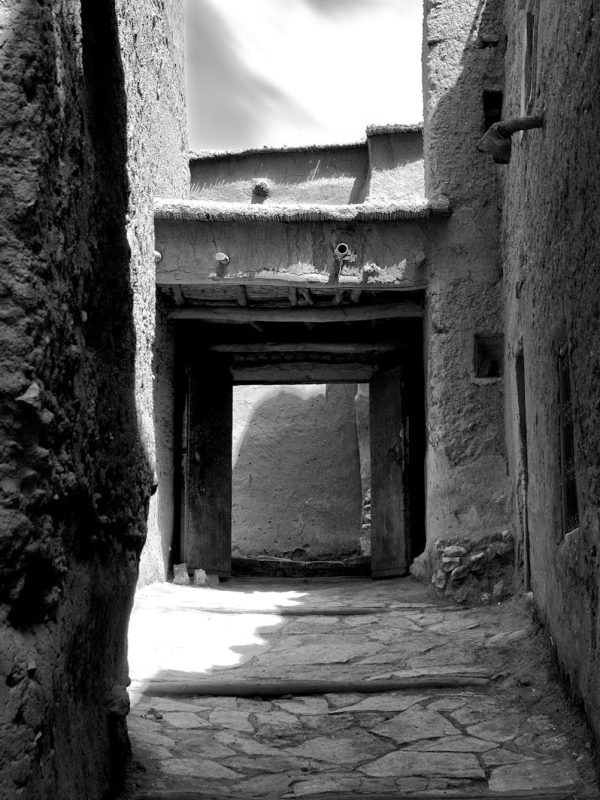 Discover Morocco 3 Days Marrakech To Fes Magic 5 Black and white view of a traditional stone alley in Ouarzazate, Morocco.