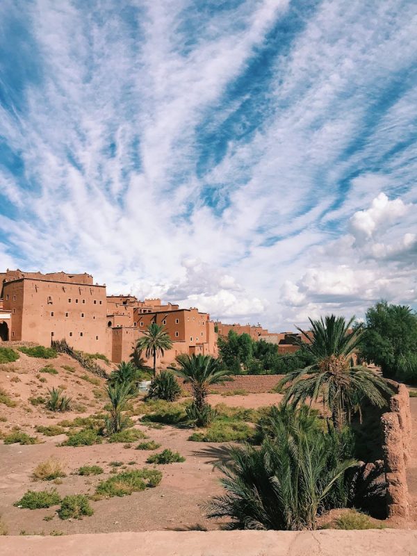 Discover Morocco 3 Days Marrakech To Fes Magic 6 Scenic view of Ouarzazate with traditional architecture and a cloudy sky, ideal for travel and nature themes.
