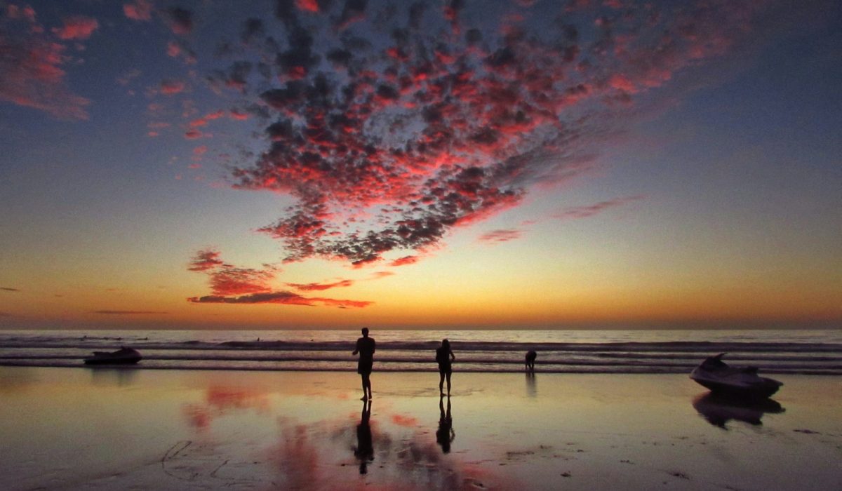 two person standing on shore